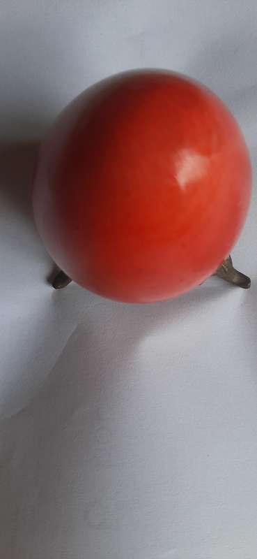RED ALABASTER EGG ON A BRASS TRIPOD