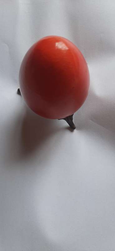 RED ALABASTER EGG ON A BRASS TRIPOD