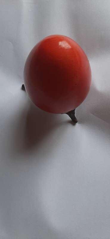 RED ALABASTER EGG ON A BRASS TRIPOD