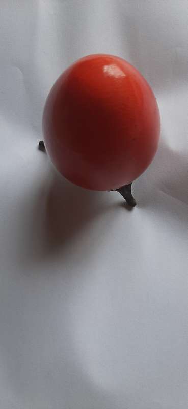 RED ALABASTER EGG ON A BRASS TRIPOD