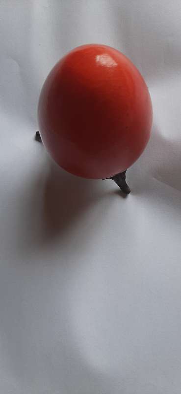 RED ALABASTER EGG ON A BRASS TRIPOD