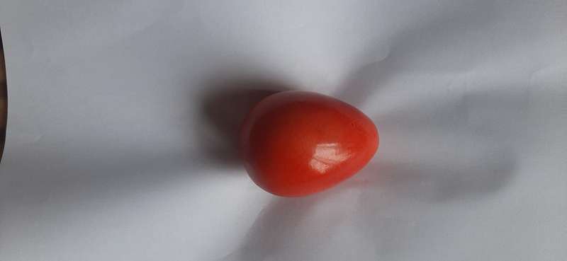 RED ALABASTER EGG ON A BRASS TRIPOD