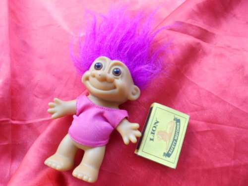 Troll with magenta coloured hair and pink shirt as per photo