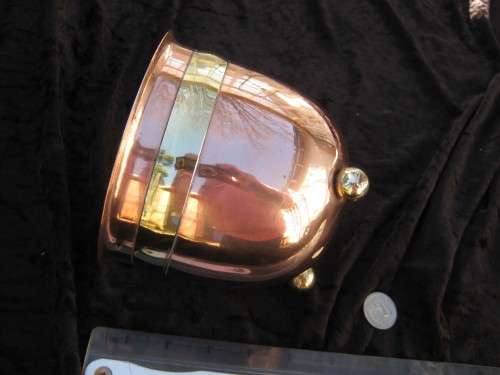 Copper planter with brass trim and feet.
