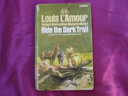 "Ride the Dark Trail" Soft cover. Louis L'Amour.