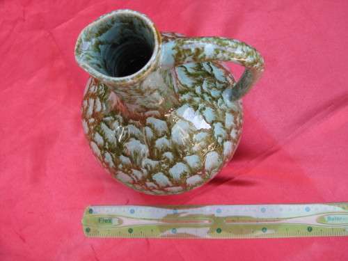 Jug and 4 mugs.  Retro but there are no markings.