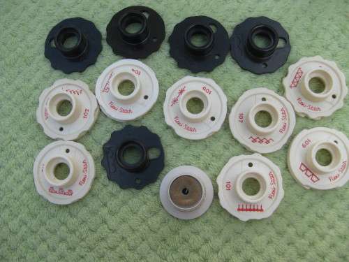 Singer machine accessories.  Stitch Pattern attachments and several plates in Singer box.