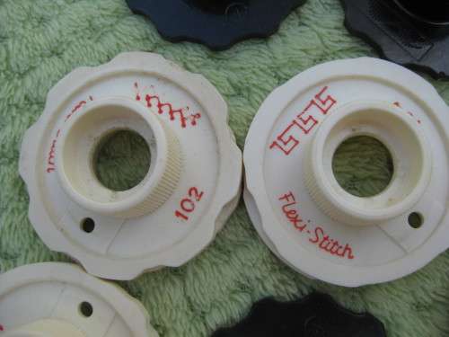 Singer machine accessories.  Stitch Pattern attachments and several plates in Singer box.