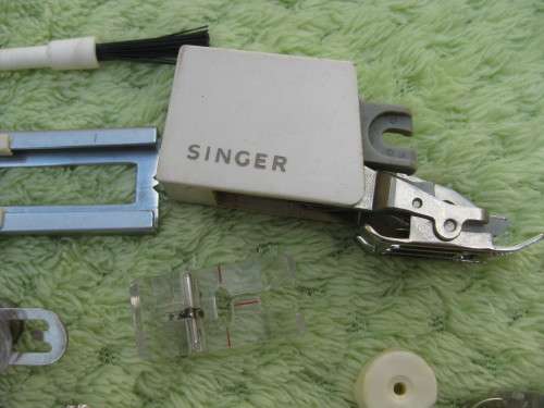 Singer machine accessories.  Stitch Pattern attachments and several plates in Singer box.