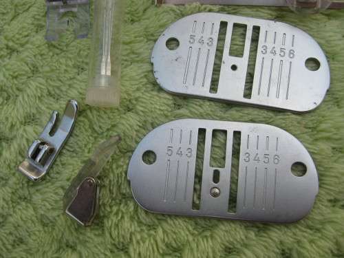 Singer machine accessories.  Stitch Pattern attachments and several plates in Singer box.