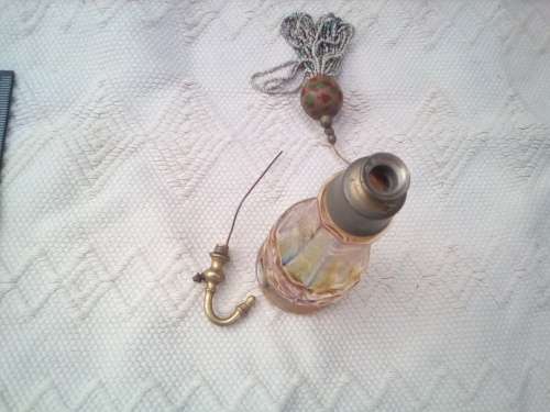 Pretty glass container with a brass screw-top attachment on top.  Not sure of its purpose - maybe sm