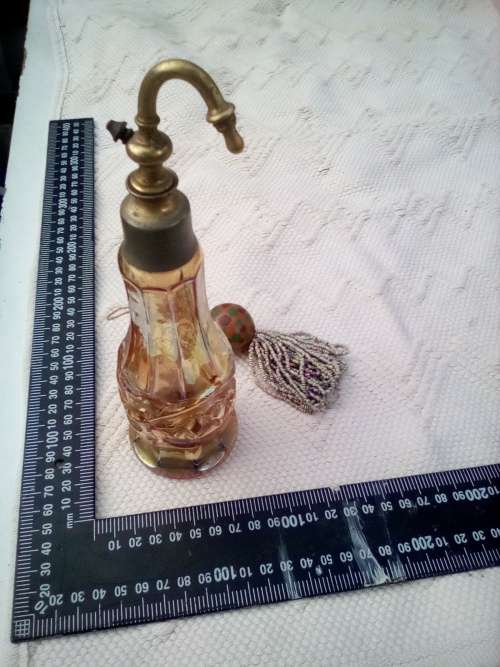 Pretty glass container with a brass screw-top attachment on top.  Not sure of its purpose - maybe sm