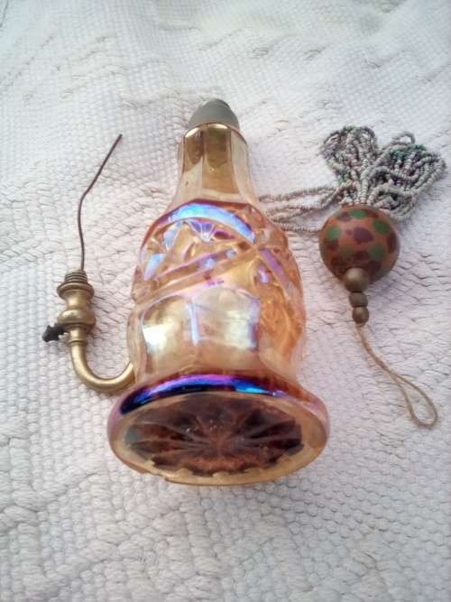 Pretty glass container with a brass screw-top attachment on top.  Not sure of its purpose - maybe sm