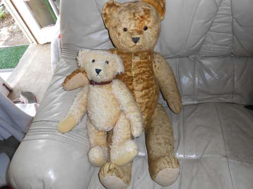 Retro, large (700mm high), straw-filled teddy bear with a small modern friend.