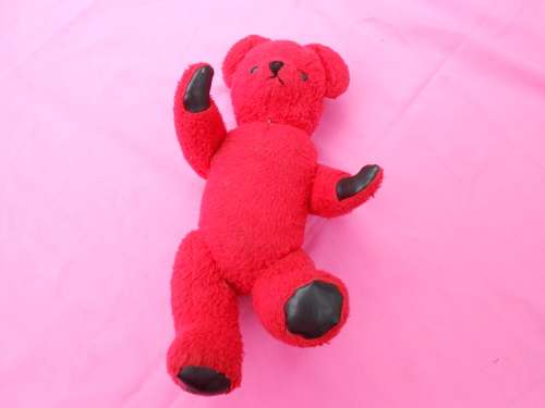 Red `Reindeer` label teddy bear.  Made in South Africa. 400mm high. Hole in right paw and foot.