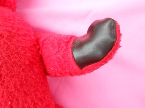 Red `Reindeer` label teddy bear.  Made in South Africa. 400mm high. Hole in right paw and foot.