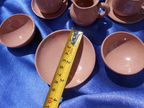 Very small, ceramic, sugar bowl, milk jug, 2 cups and saucers, 2 bowls and one cake plate.