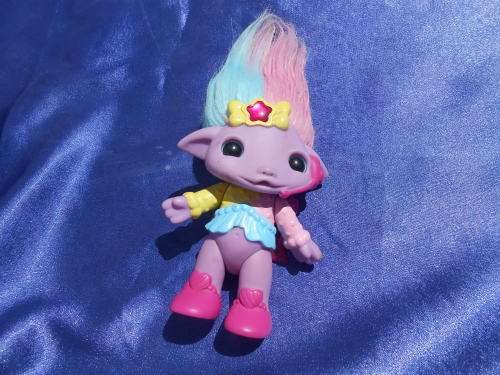 Plastic, purple-coloured doll.