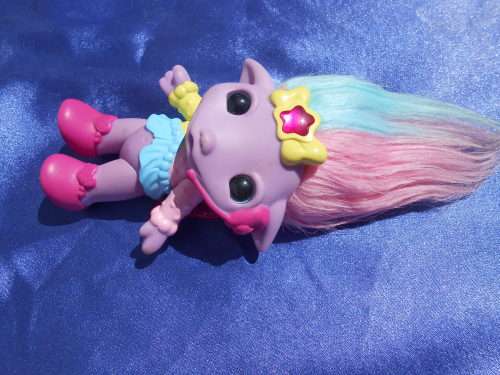 Plastic, purple-coloured doll.