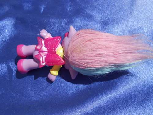 Plastic, purple-coloured doll.