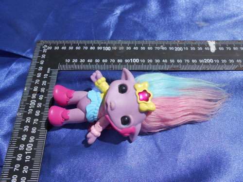 Plastic, purple-coloured doll.