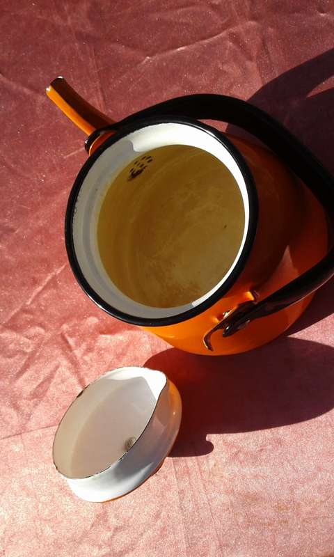Enamel,  orange-coloured kettle.  Made in Poland.