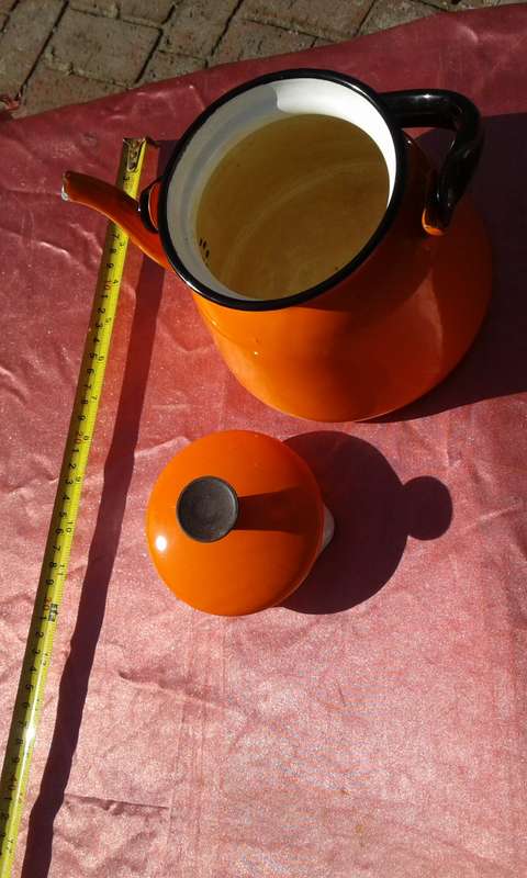 Enamel,  orange-coloured kettle.  Made in Poland.