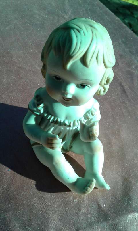 Little girl ornament.  No markings.