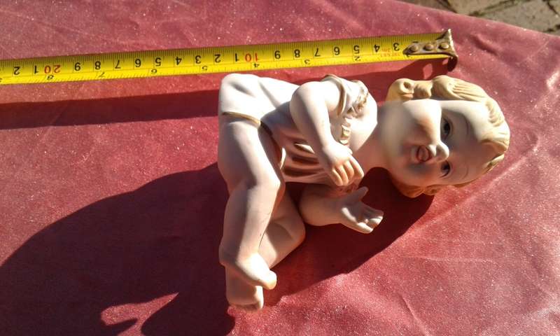 Little girl ornament.  No markings.