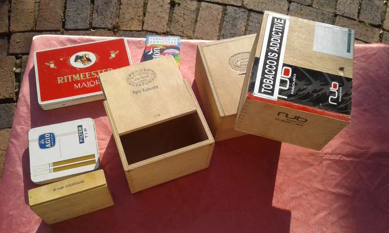 EMPTY wooden cigar boxes and cigarette tins.