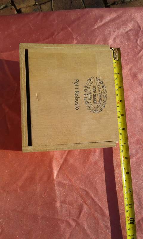 EMPTY wooden cigar boxes and cigarette tins.
