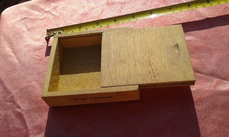 EMPTY wooden cigar boxes and cigarette tins.