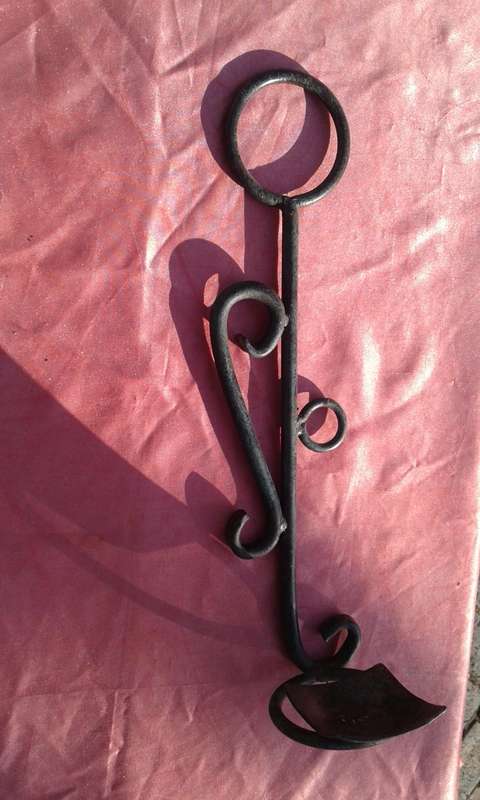 Hanging, metal candle holder.