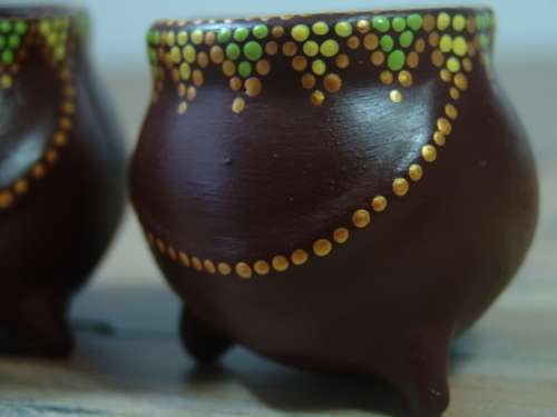 A pair of Vintage small African decorated three leg Pot Ornaments
