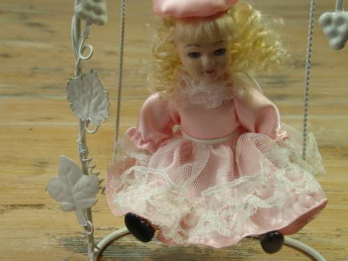 Set of two Vintage collectable rare porcelain Dolls on Swings