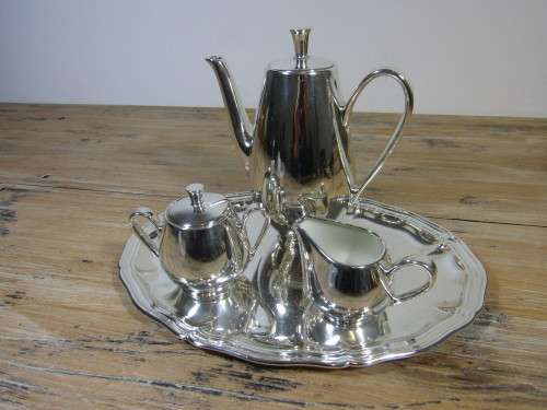 Vintage 4 piece porcelain tea set with complete and heavy silver overlay on silver plated Tray