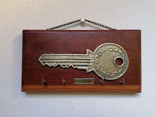 Brass key on wood Keyholder