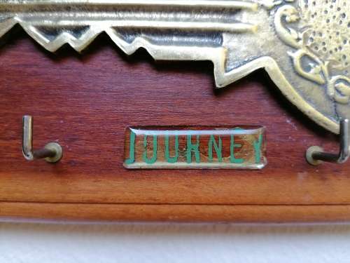 Brass key on wood Keyholder