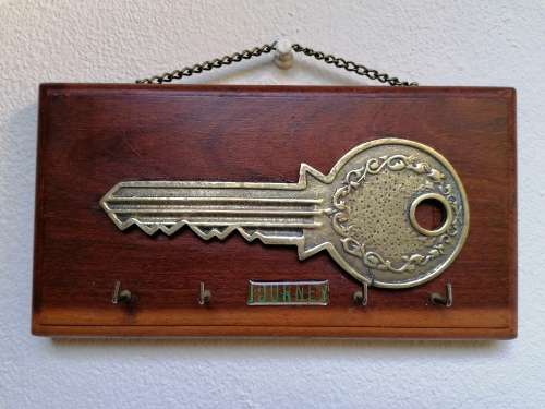 Brass key on wood Keyholder