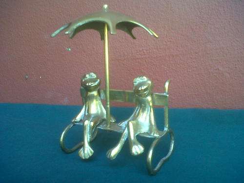 BRASS FROGS ON A BENCH