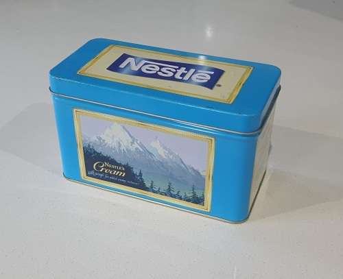 NESTLE tin as per photos