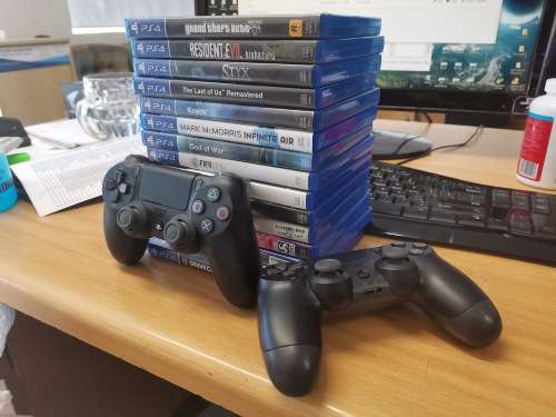 Sony PS4 1TB (SSHD) + 2 Controllers (One is a Double Shock 4 and one is original) + 14 Games+2M HDMI