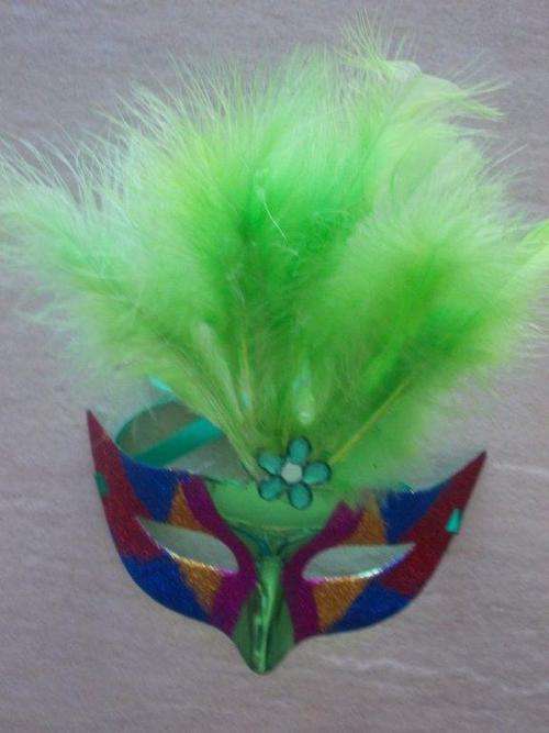 Green mask with lights and feathers