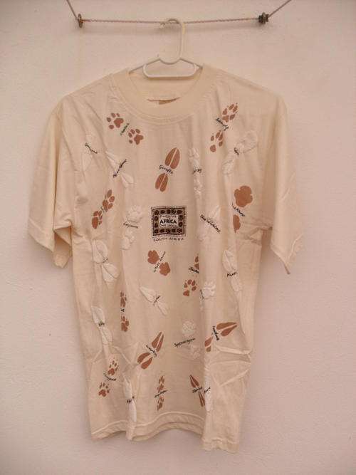 cream coloured t shirt with animal footprints