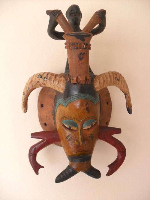 African mask from Ghana with man ploughing his field
