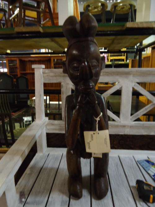 A Yaka Kneeling man with a curved nose Statue