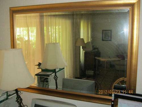 Big mirror in wooden frame painted gold