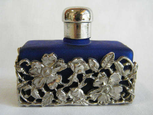 Blue perfume bottle with silver plated lid and flower detail - as per photo