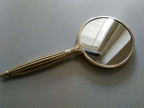 Vintage hand held mirror...mirror both sides. BRASSFRAME  ART DECO