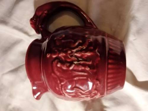 Lucia ware small Burgundy jug... 11cm  tall